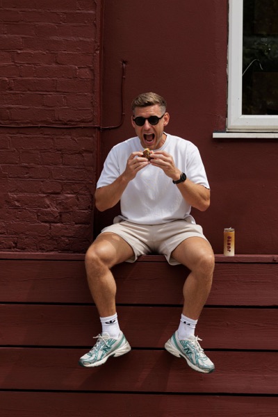 A customer eating outside the Junto cafe — photo 235