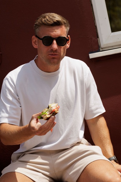A customer eating outside the Junto cafe — photo 241
